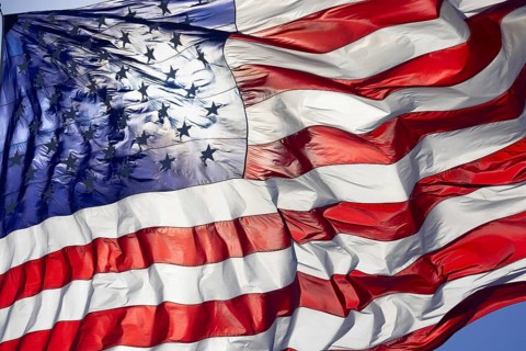 Dramatic backlit american flag waving in the wind