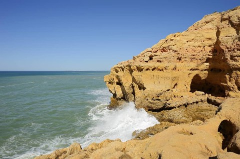 Surf on the rocky coast, Carvoeiro, Algarve, Portugal