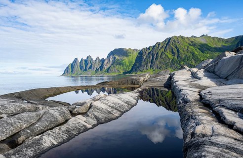 Reflection in a tidal pool, rocky coast of Tungeneset, Devil's Teeth, Okshornan, Ersfjorden, Senja