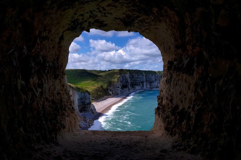 View through the eye of the panda, L'oeil du Panda, rock window, cave, in the rock arch Falaise