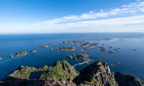 View of the sea and archipelago islands with the village of Henningsvær, Festvagstinden peak,