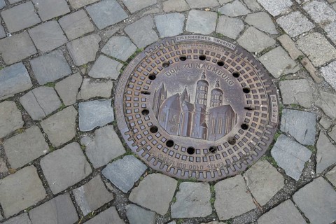 Manhole cover with cathedral as landmark, cobblestones, floor, inscription, cathedral square,