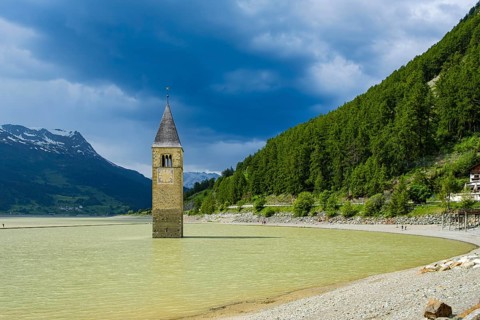 Bell tower of the former parish church of St Catherine in the sunken village of Alt-Graun in Lake