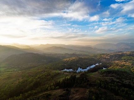 Sunset over Mountains and Coniston Water from drone, Lake District National Park, Cumbria, England,