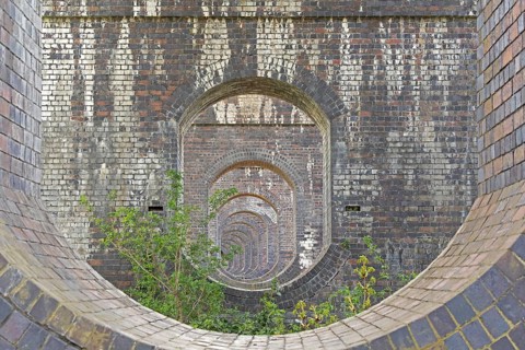 View through openings in piers of a railway viaduct, Stanway, Broadway, The Cotswolds, England,