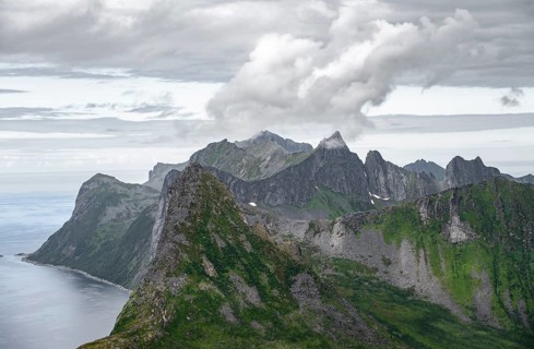 View of mountain peaks on the headland of Fjordgård with peak Segla, fjords Øyfjorden and