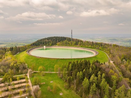 Upper reservoir Reservoir on a wooded hill with observation tower and green meadows, Glems