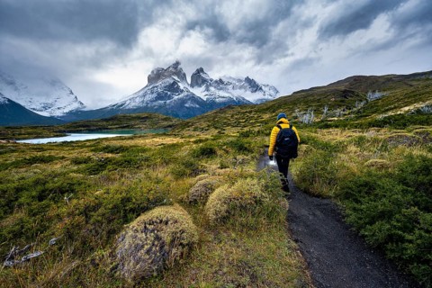 Hikers on the way to the Mirador de los Cuernos, Cuernos del Paine mountain range, dramatic sky,