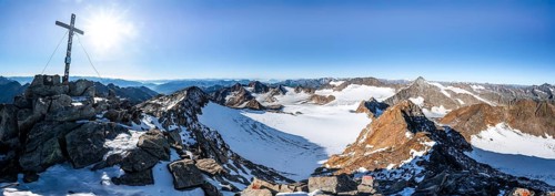 Mountain panorama at the Wilder Freiger summit with summit cross, picturesque high mountain