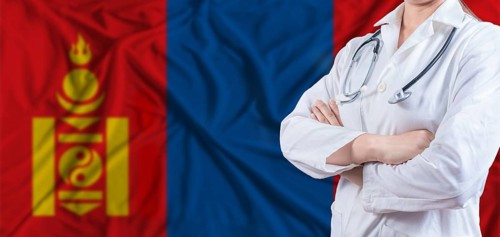 Doctor with crossed arms on Mongolia flag. Mongolia health and care concept. Female doctor on