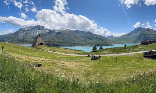 Panoramic view from plateau above Lanslebourg-Mont-Cenis to reservoir Lac du Mont Cenis left Museum