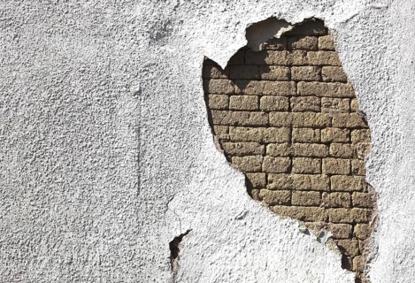 Building damage, wall damage, flaking plaster and wall paint, bricks