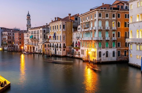 View of the Grand Canal at sunset, picturesque evening mood with illuminated palazzos on the canal