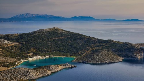 Coastal landscape with hills and blue water under a clear sky, Holy Week, Panormitis Bay,