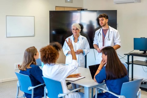 Doctors and nurses participating in a medical conference, sharing insights and expertise for better