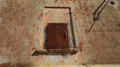 Lost Place, Locked rusty door in a weathered wall under summer light, Radio Station, WW2, Agios