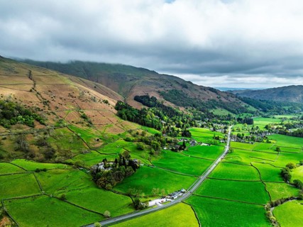 Farms and Mountains over road A591 from a drone, Grasmere Lake, Grasmere, Ambleside, Lake District,