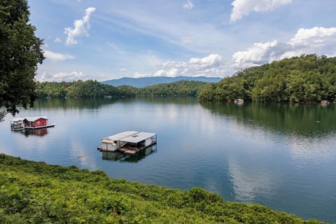 View of a house boats on Fontana Lake as seen from the open air car of the Great Smoky Mountains