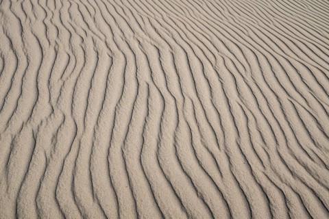 Wave-like wind-formed sand structures in close-up, Hvide Sande, North Sea, Denmark
