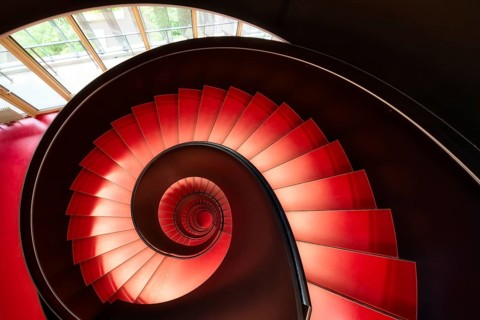 Modern red spiral staircase in an educational building, Zurich, Switzerland