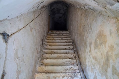 An old, narrow staircase leading deep into the darkness of an underground passage, Lost Place, Lago
