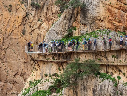 Tourists on the elevated path of the caminito del rey, along a deep gorge, Andalusia, Spain