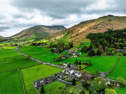 Farms and Mountains over road A591 from a drone, Grasmere Lake, Grasmere, Ambleside, Lake District,