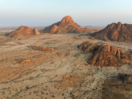 The isolated Spitzkoppe mountain (1728 m) majestically rises above the surrounding desert plains.