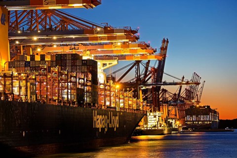 Container ships at the Eurogate container terminal in the evening with an atmospheric sunset,