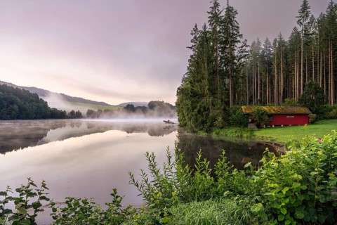 Lake Blaibach on a cloudy morning. Fog over the lake, rising water vapour. Blaibach, district of