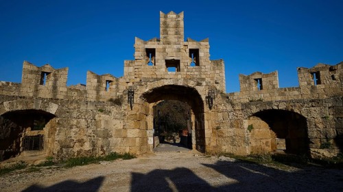 St Paul's Gate, Medieval stone castle gate under a clear blue sky, harbour area, Rhodes Town,