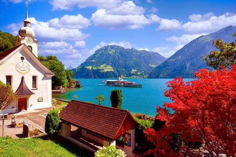 Steamboat on Lake Uri, Roman Catholic church in the village of Bauen, Fronalpstock mountain behind,