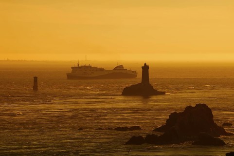 Phare de la Vieille lighthouse and ferryboat at sunset, Pointe du Raz, Cap Sizun, Finistere