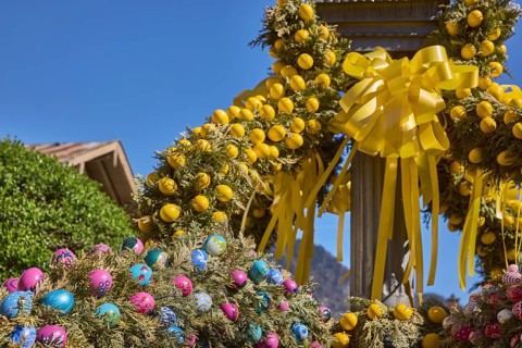 Easter fountain, Easter decoration, blown out coloured Easter eggs, trees, historical buildings,