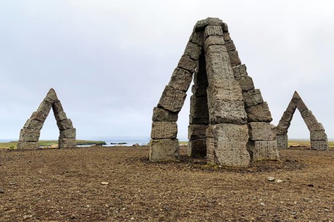 Gravel path to the Arctic Henge, large stone gates, basalt, landmark, in barren landscape,