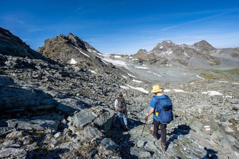 Mountaineer in rocky mountain landscape, hike between Col de Plafleuri and Col du Louvie, Valais