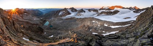 Panorama at sunrise with sun star, high mountain landscape, view of blue glacial lakes, mountain