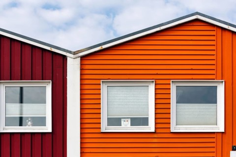Colourful lobster huts, wooden façade with three windows, façade detail in the harbour, Heligoland,