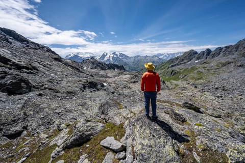 Mountaineer in rocky mountain landscape at the Col du Louvie, view of the summit of the Grand