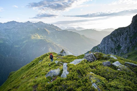 Mountaineers in a picturesque mountain landscape in the atmospheric evening light, view from the