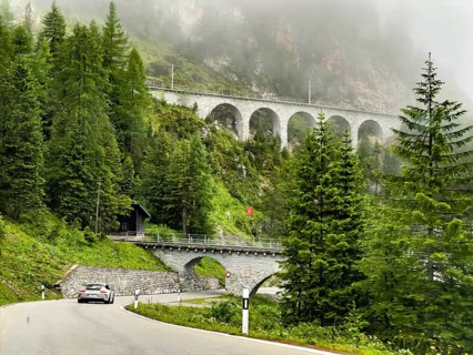 View of front Albula road Veja Alvra from Albula Pass towards Bergün with viaduct for railway in