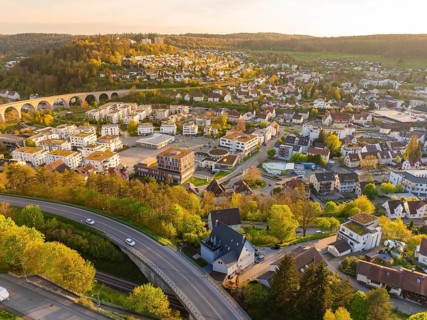 Aerial view of town with viaduct, houses and green hills, Nagold, Black Forest, Germany