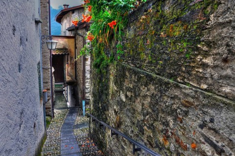 Narrow Street with Old Rustic House and Beautiful Flowers in Ronco sopra Ascona, Ticino,