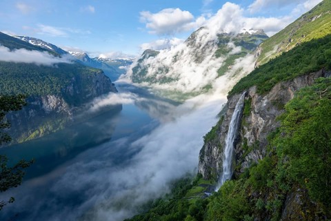 Gjerdefossen waterfall, at Ørnesvingen viewpoint, atmospheric clouds over the fjord in the morning