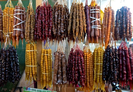 Traditional Georgian sweets Churchkhela made from walnuts and thickened grape juice, market stall