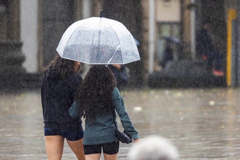 Rainy weather in Stuttgart. People with umbrellas hurry through the rain on Königstraße. Stuttgart,