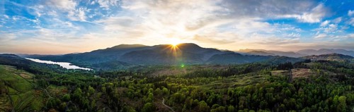 Panorama of Sunset over Mountains and Coniston Water from drone, Lake District National Park,