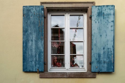 Window with blue shutters and reflections, Alsace, France