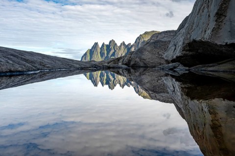 Reflection in a tidal pool, rocky coast of Tungeneset, Devil's Teeth, Okshornan, Ersfjorden, Senja
