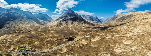 Panorama of Buachaille Etive Beag and Three Sisters in Glencoe over Moors and Road A82 from a